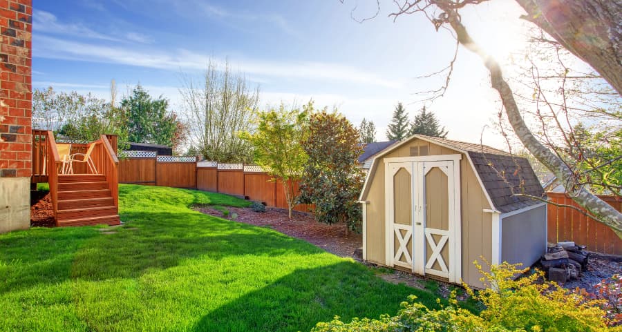 Fenced backyard with storage shed in Salem